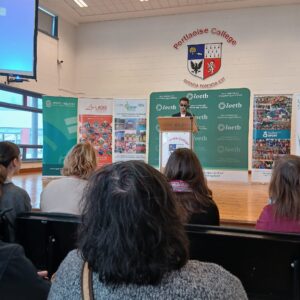 Student Jorge wearing sunglasses, discussed his experience of the VIP Hub, standing at a podium